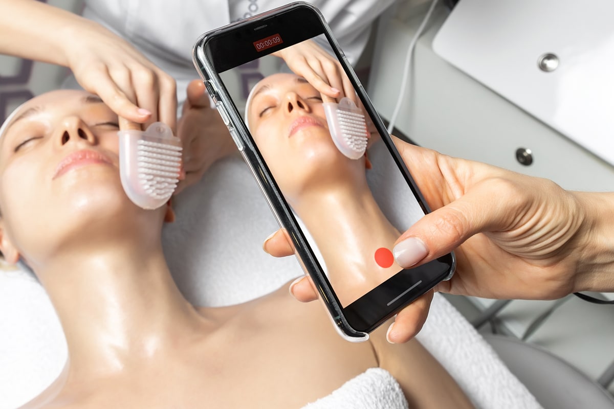 taking a photo of skin treatment to post on social media
